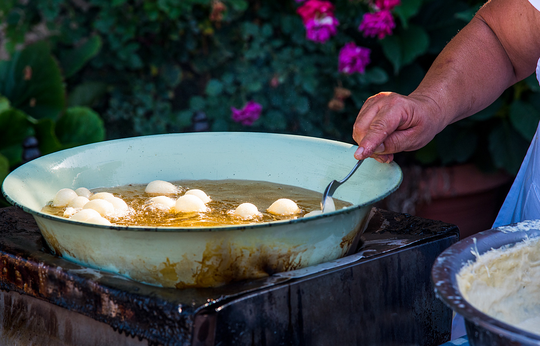 A woman cooks loukoumades in Corfu