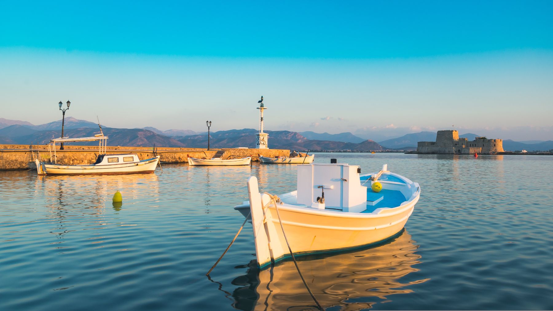 Fishing boats moored in the harbour of Napflon in Greece