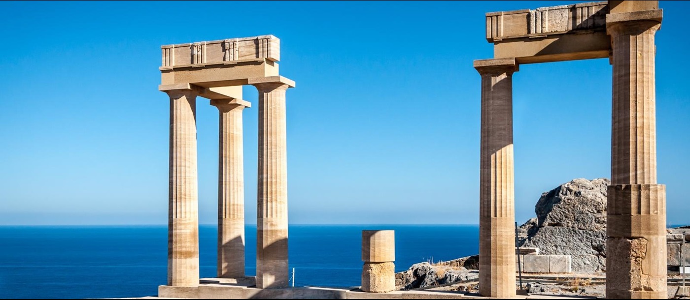 Two sets of columns on a island with the view of the sea