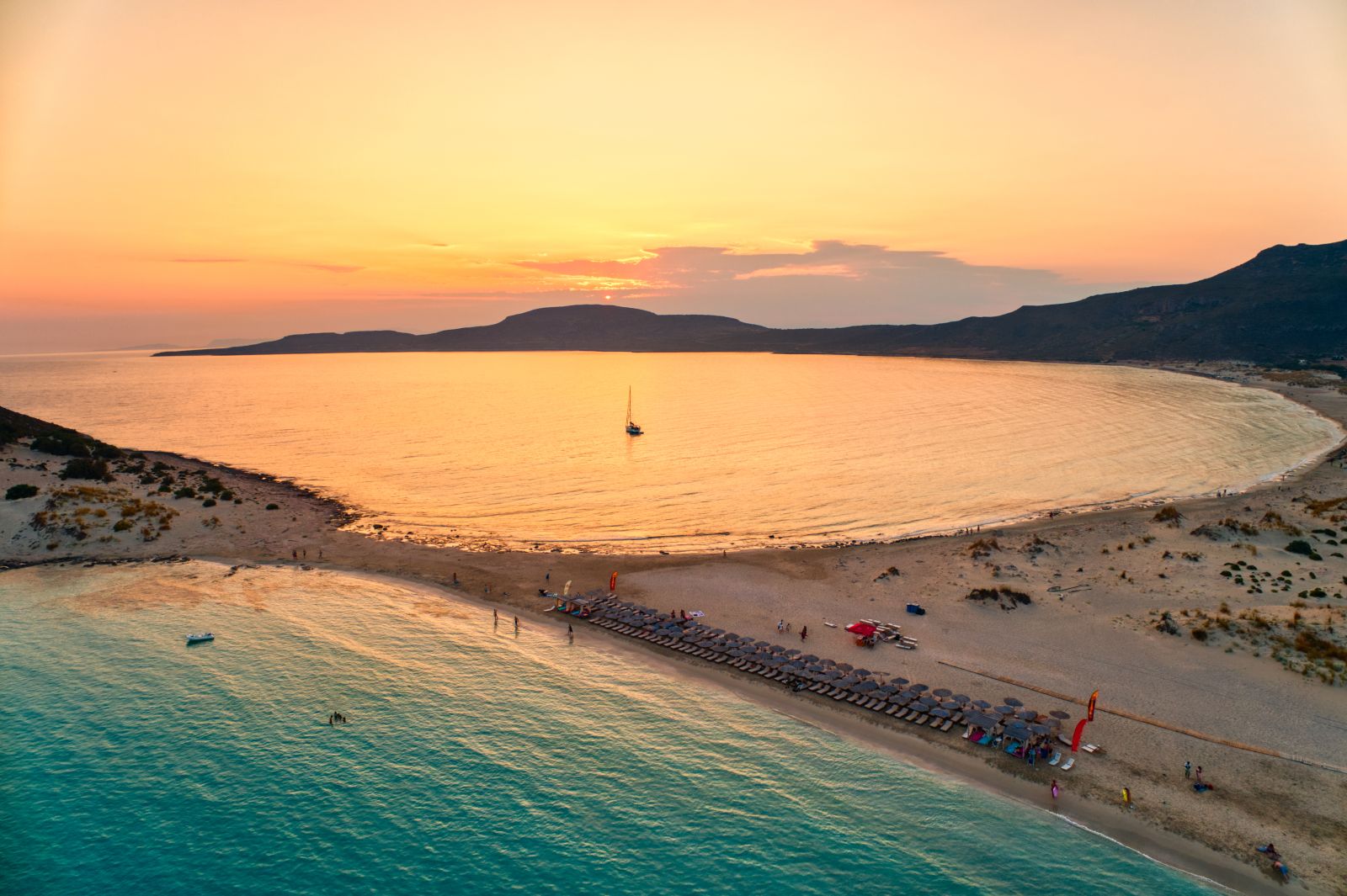 Aerial view of the beach and bay of Simos at sunset in the Greek Islands
