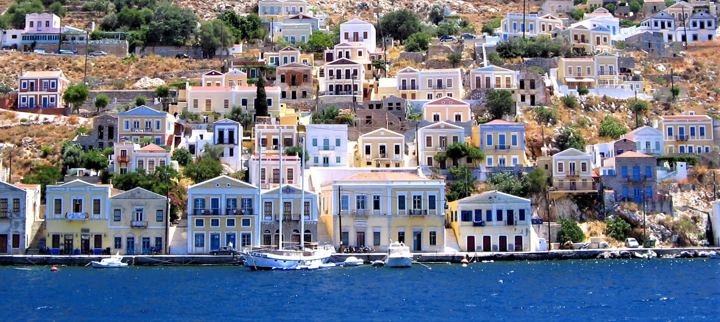 Rows of colourful houses on the harbourfront in Symi, Greece