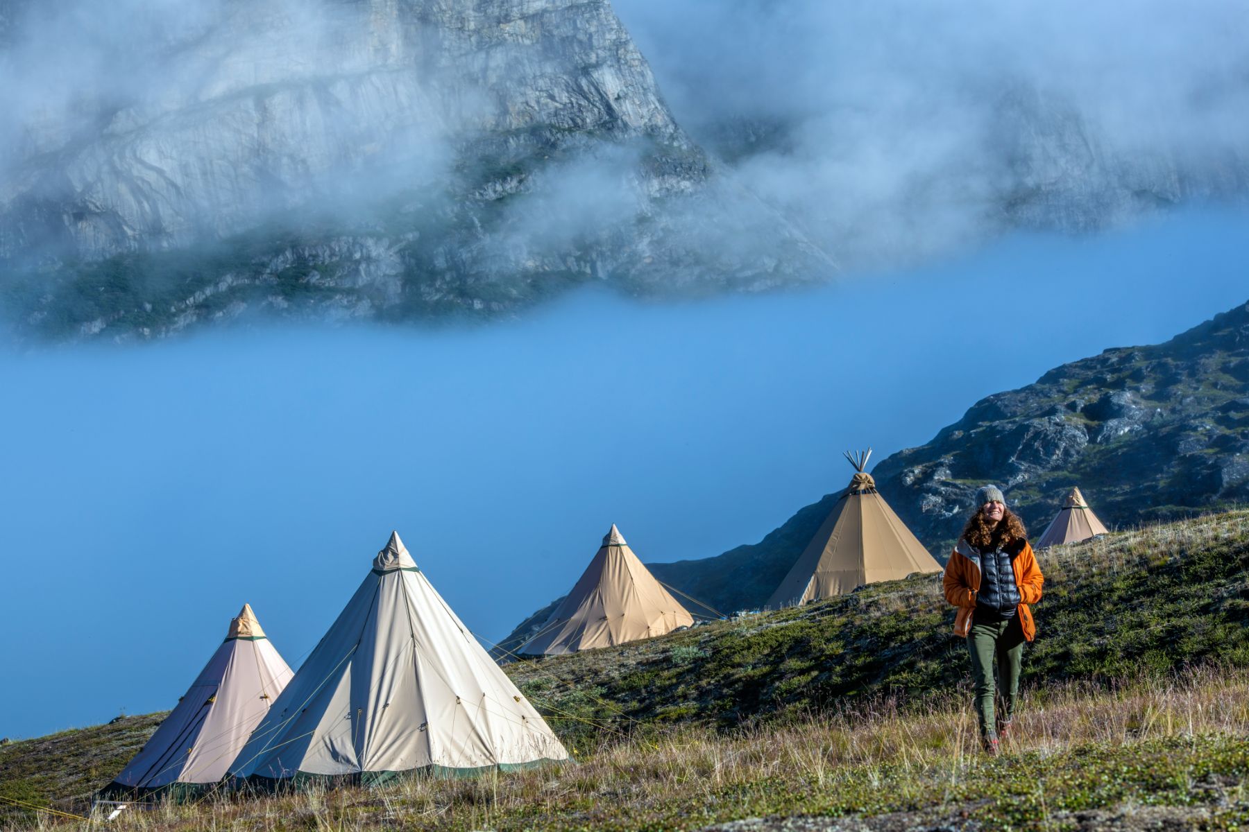 Lady walking around the pristine surrounding of Camp Kiattua in Greenland