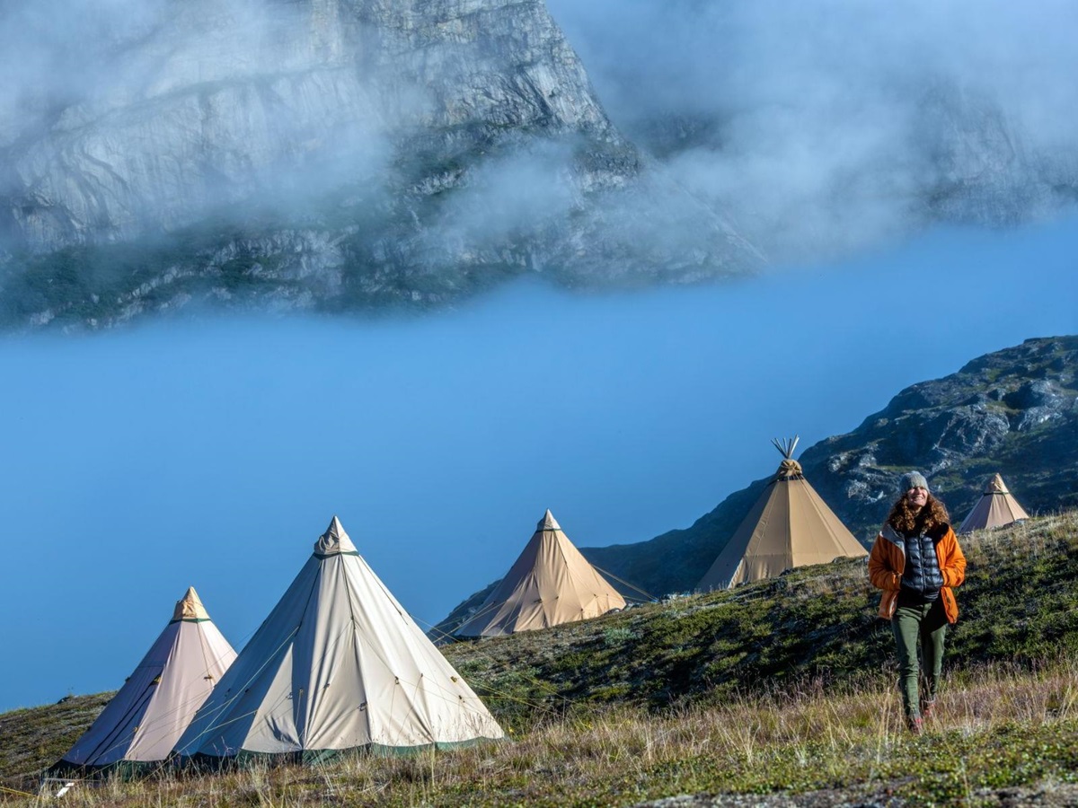 Lady walking around the pristine surrounding of Camp Kiattua in Greenland