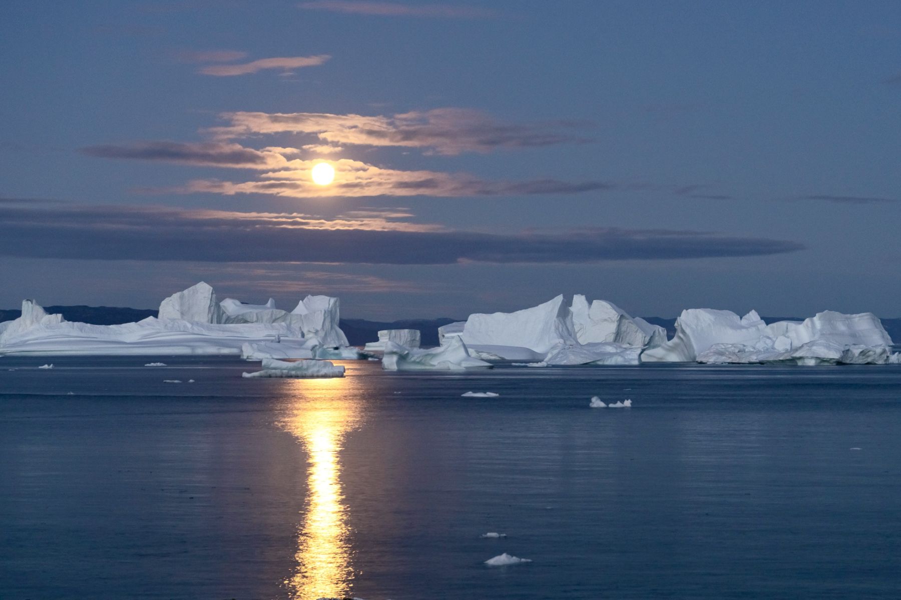 Night view of icebergs in Disko Bay Greenland seen from Camp Saqqaq