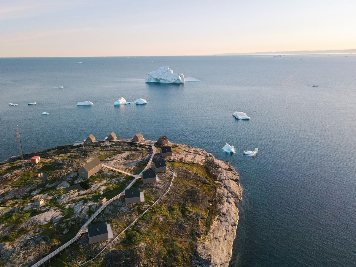 Aerial view of Ilimanaq Lodge in Greenland with an outlook of icebergs in Disko Bay