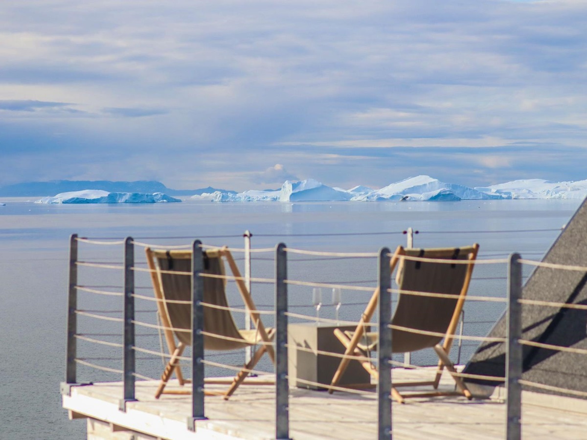 Deckchairs and view of icebergs in Disko Bay from a private terrace at Ilimanaq Lodge Greenland