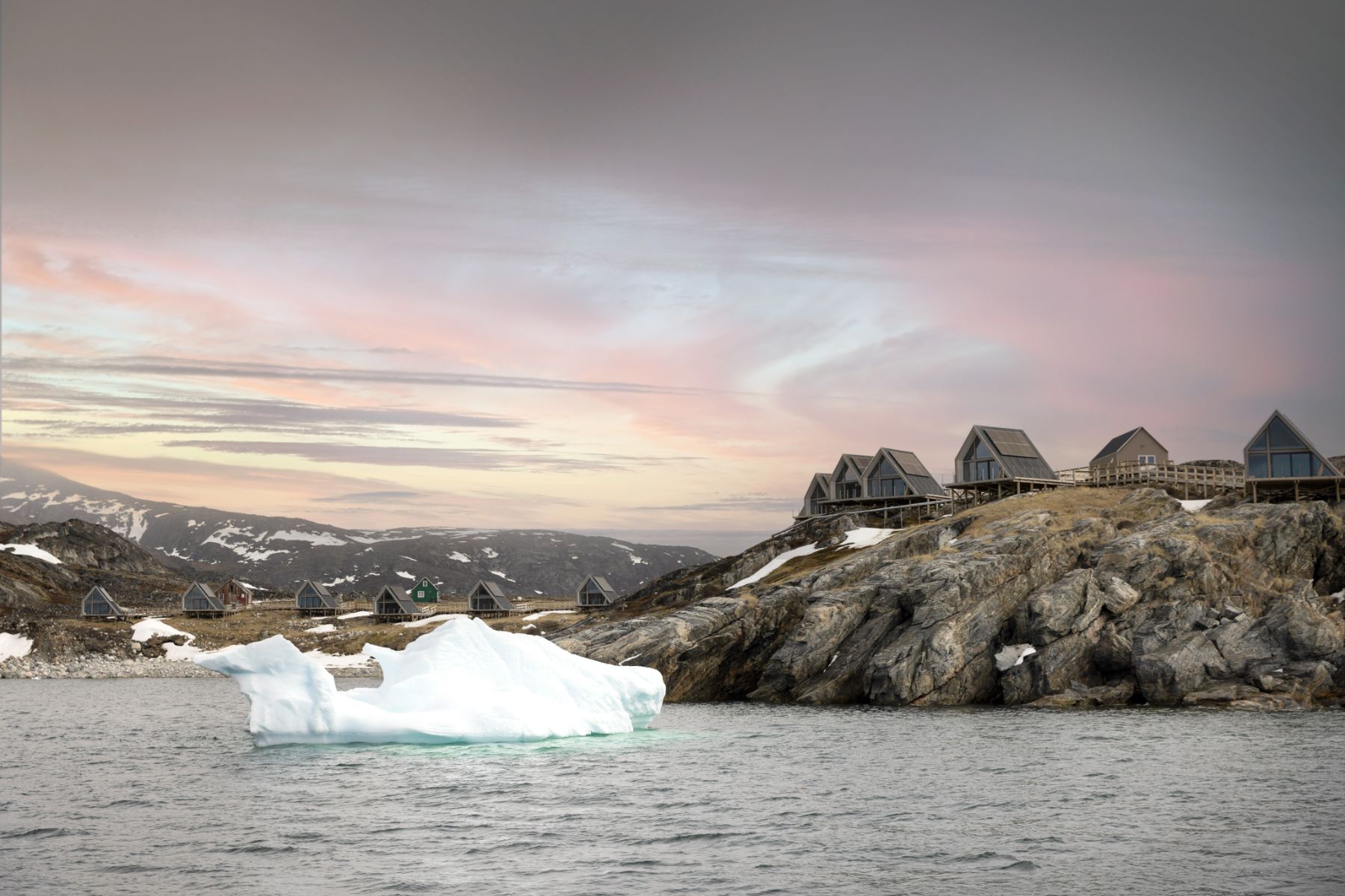 Iceberg floating in front of the bungalows at Ilimanaq Lodge Greenland