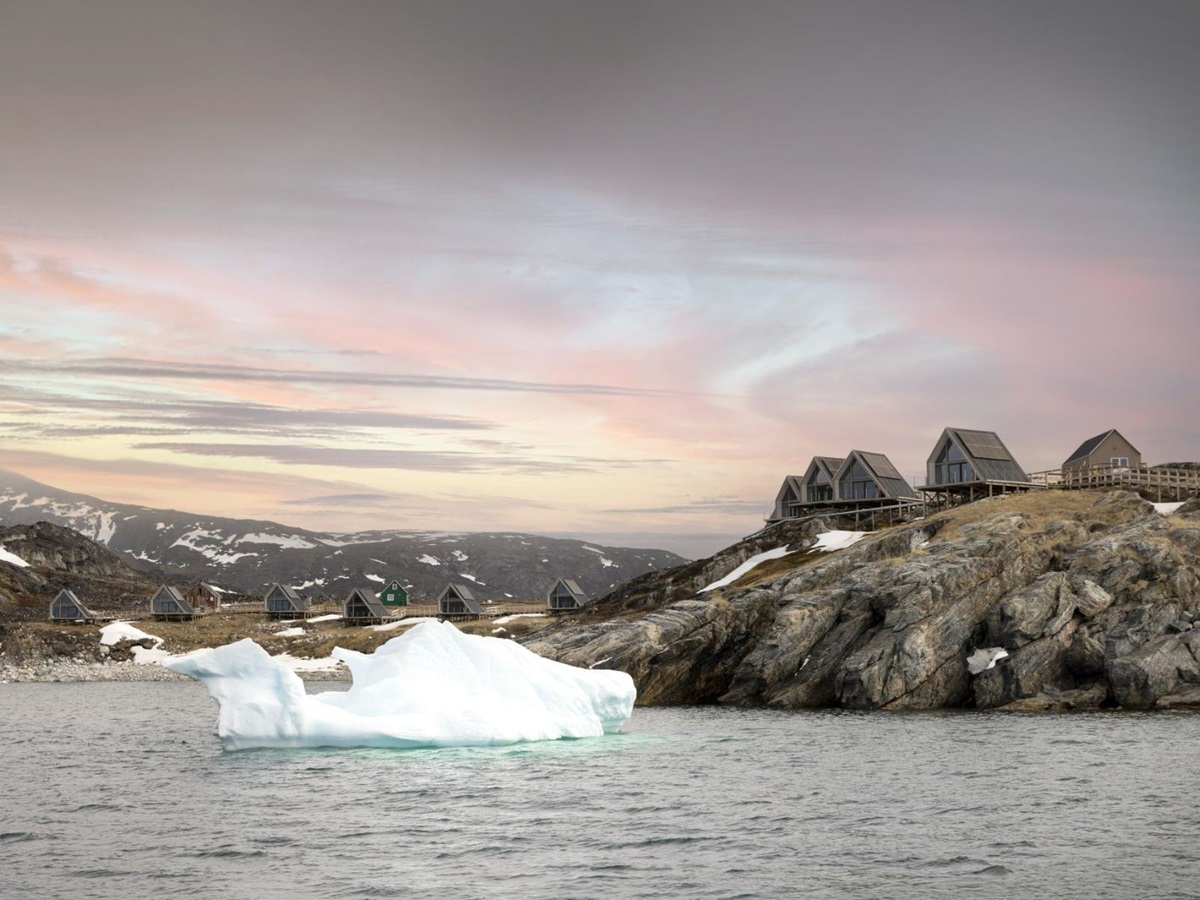 Iceberg floating in front of the bungalows at Ilimanaq Lodge Greenland