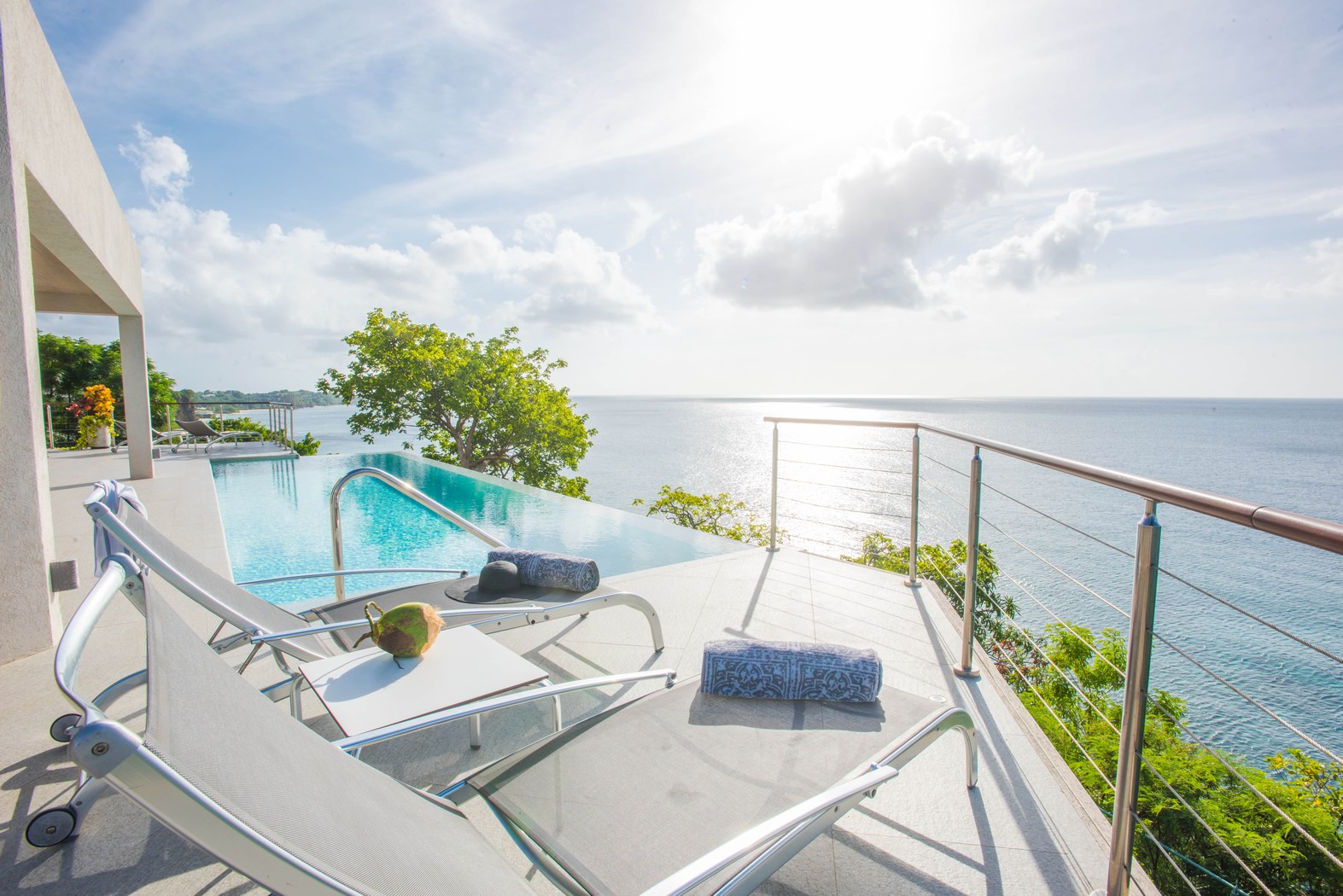 The sundeck with sunloungers and pool at Laluna, Grenada