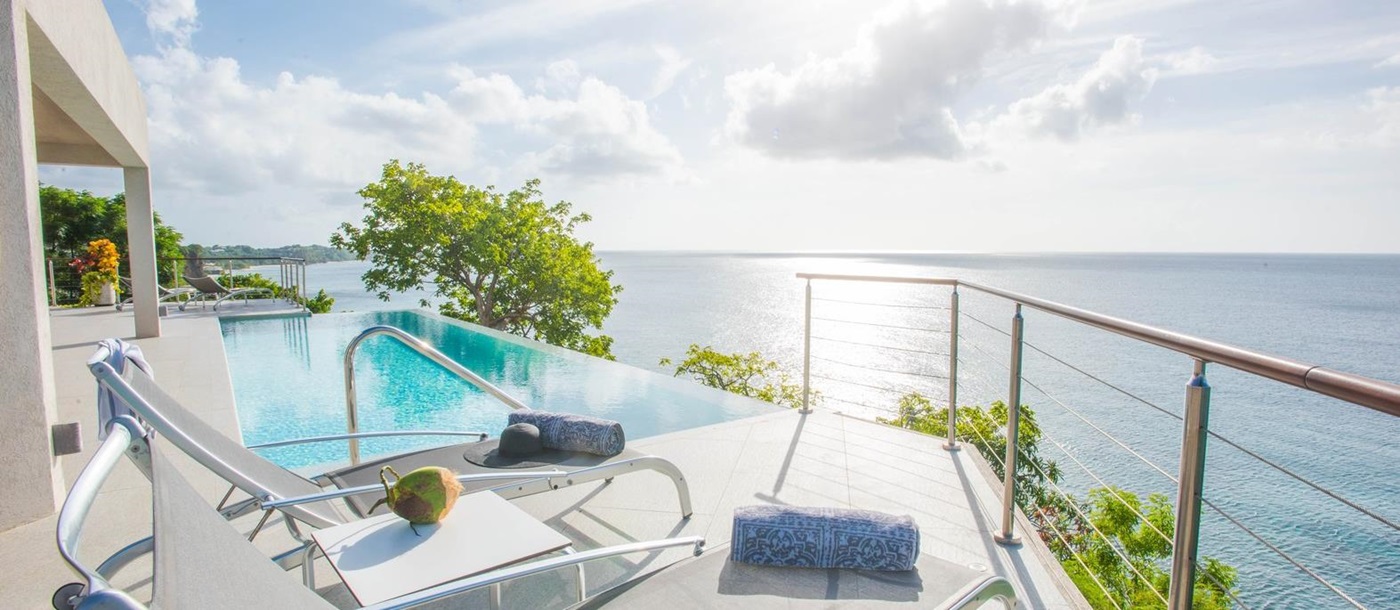 The sundeck with sunloungers and pool at Laluna, Grenada