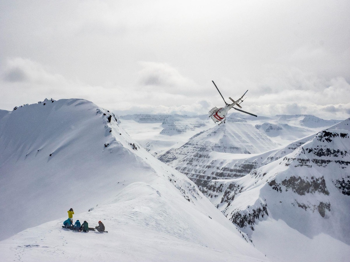 Heli skiing in the snowy mountains from Deplar Farm in Iceland