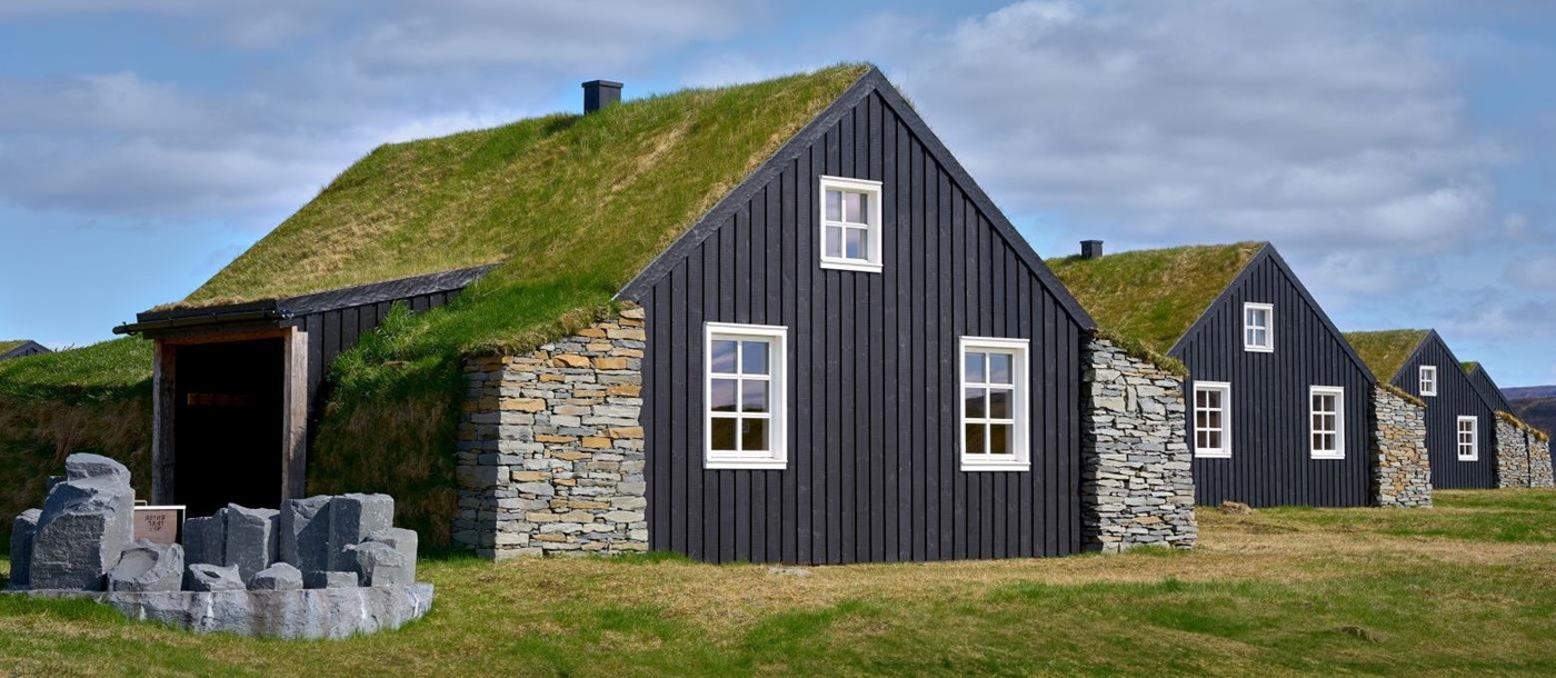 The turf covered roofs of the cottages at Torfhus Retreat hotel in Iceland