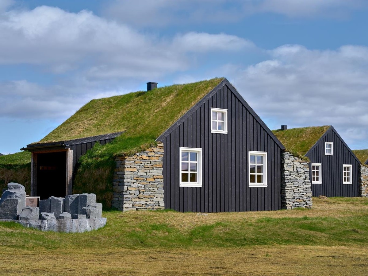 The turf covered roofs of the cottages at Torfhus Retreat hotel in Iceland