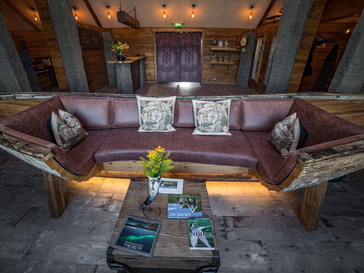 Wooden boat converted into a sofa at Torfhus Retreat hotel in Iceland