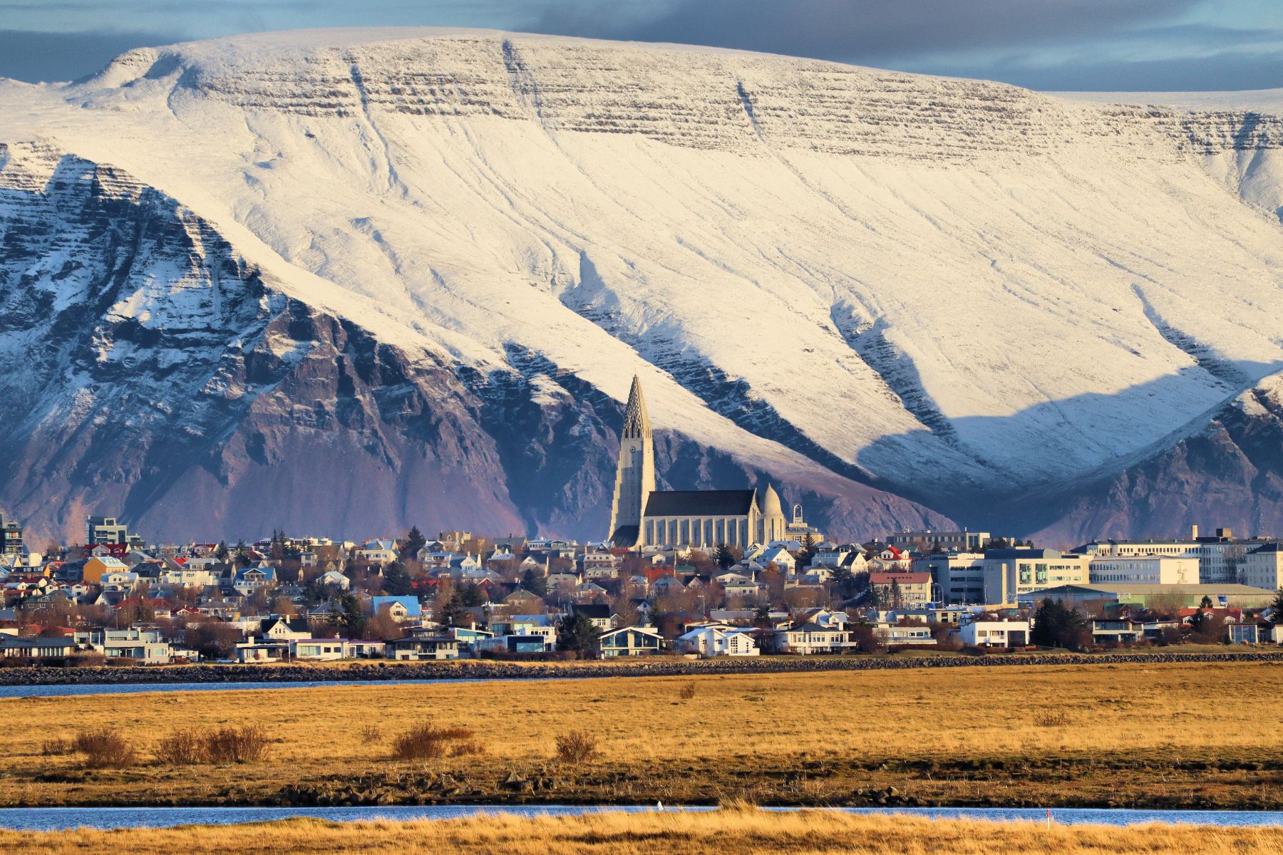 Distant view of Reykjavik in Iceland with a snowy mountain backdrop