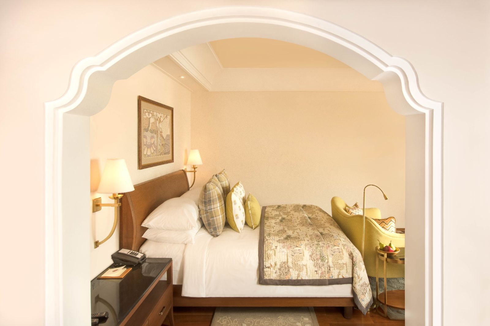Guest room with king sized bed in bright bedroom in luxury hotel in India
