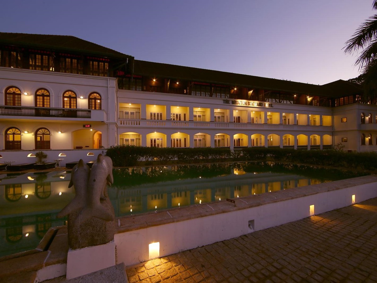 The exterior of the Brunton Boatyard hotel India by night