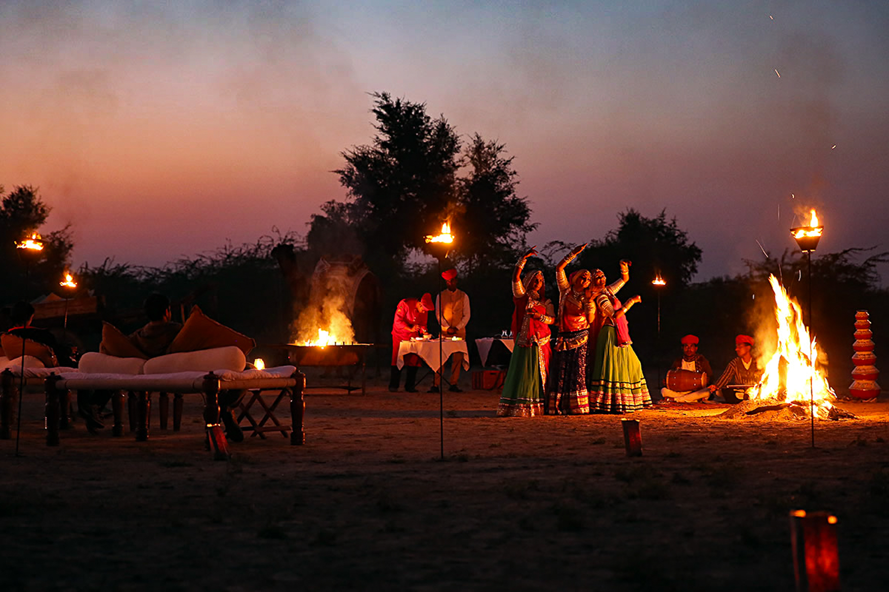 Dancers round the fire at Mihir Garh in India