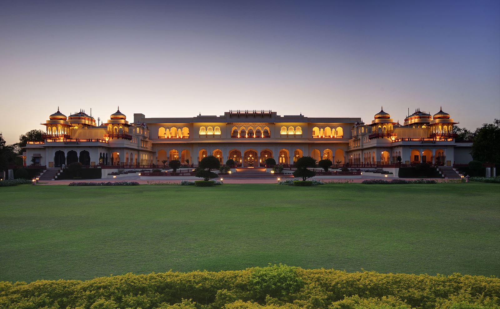 The exterior of  Rambagh Palace in India by night