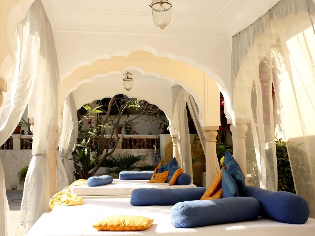 Day beds by the pool at the Samode Haveli hotel in Jaipur India