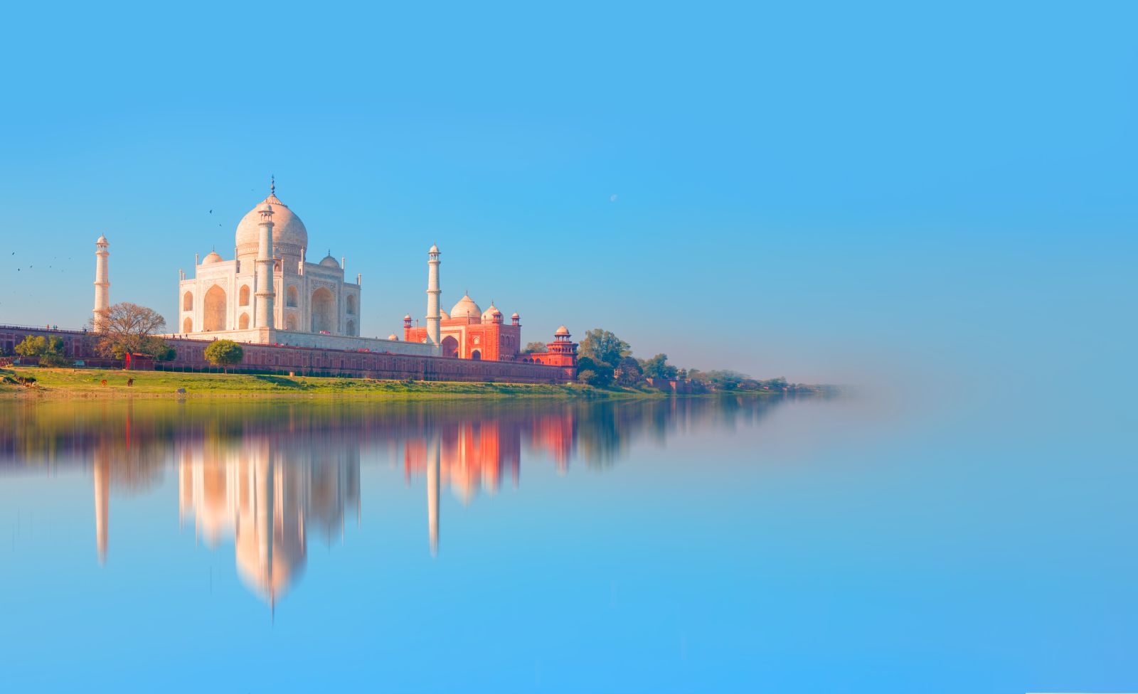 Distant view of the Taj Mahal in reflection