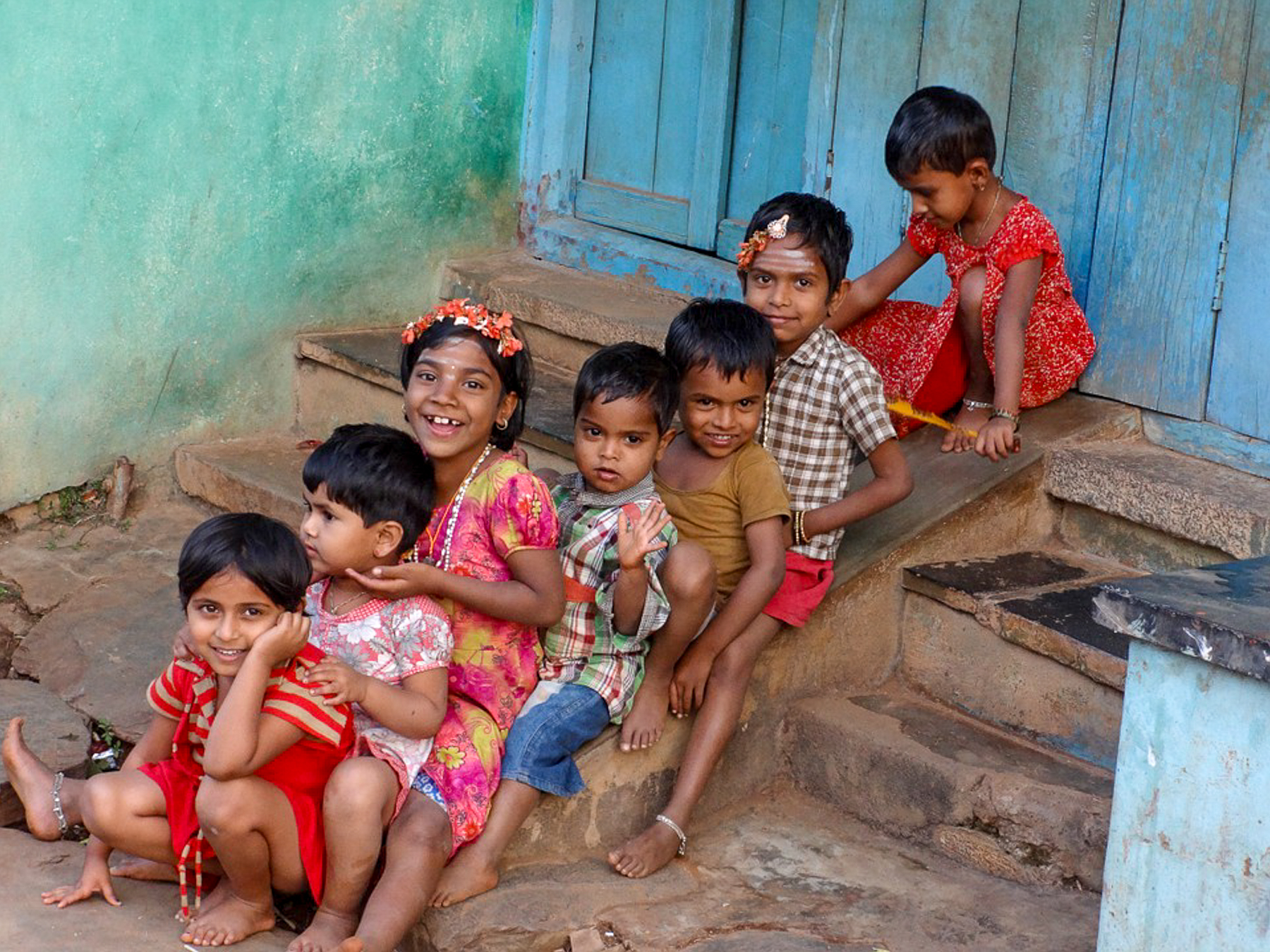 Indian children sitting on stairs