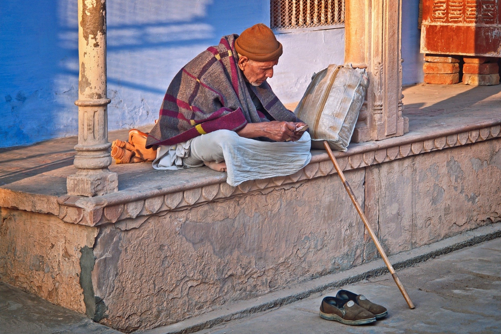 Old Indian man sitting down alone