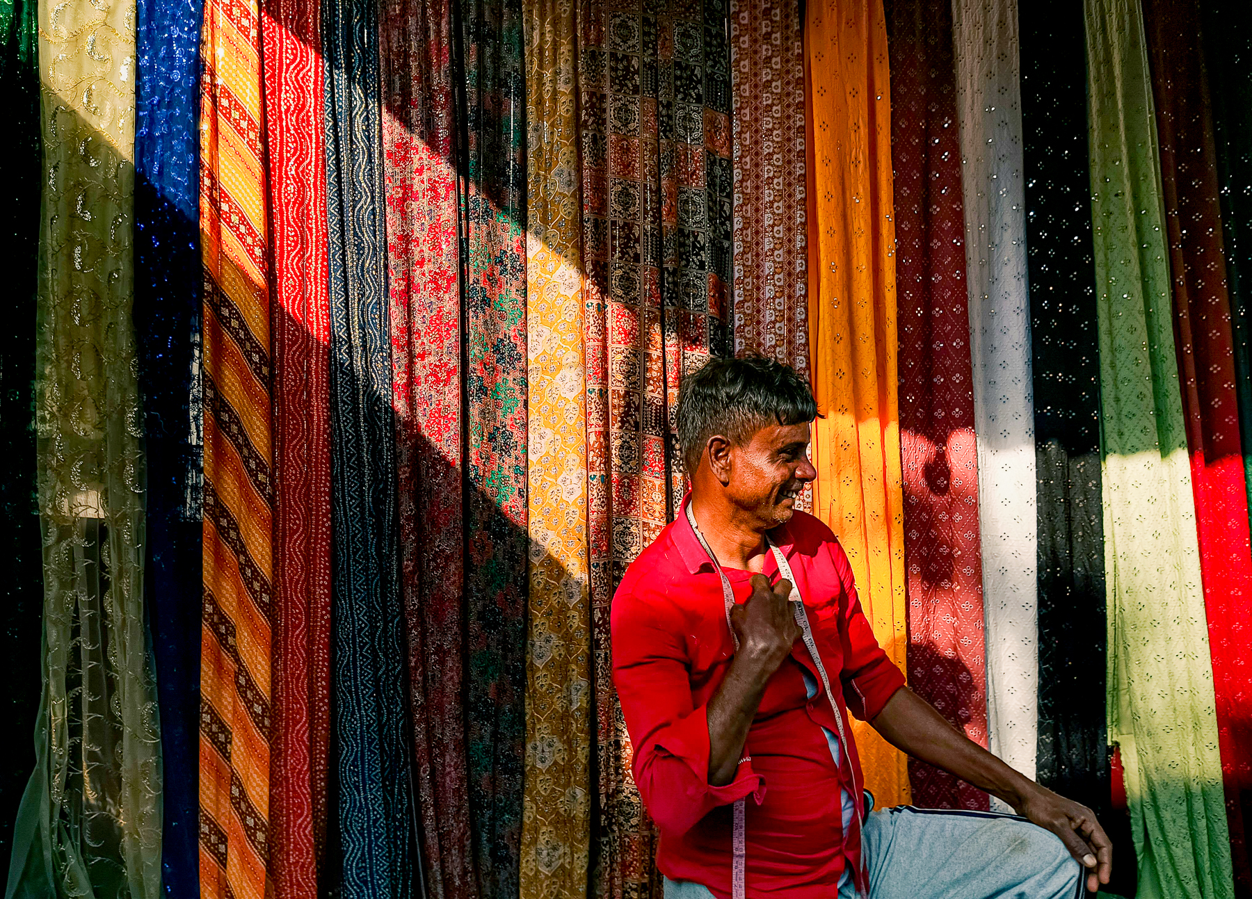 A weaver selling wares at a market in Kolkata