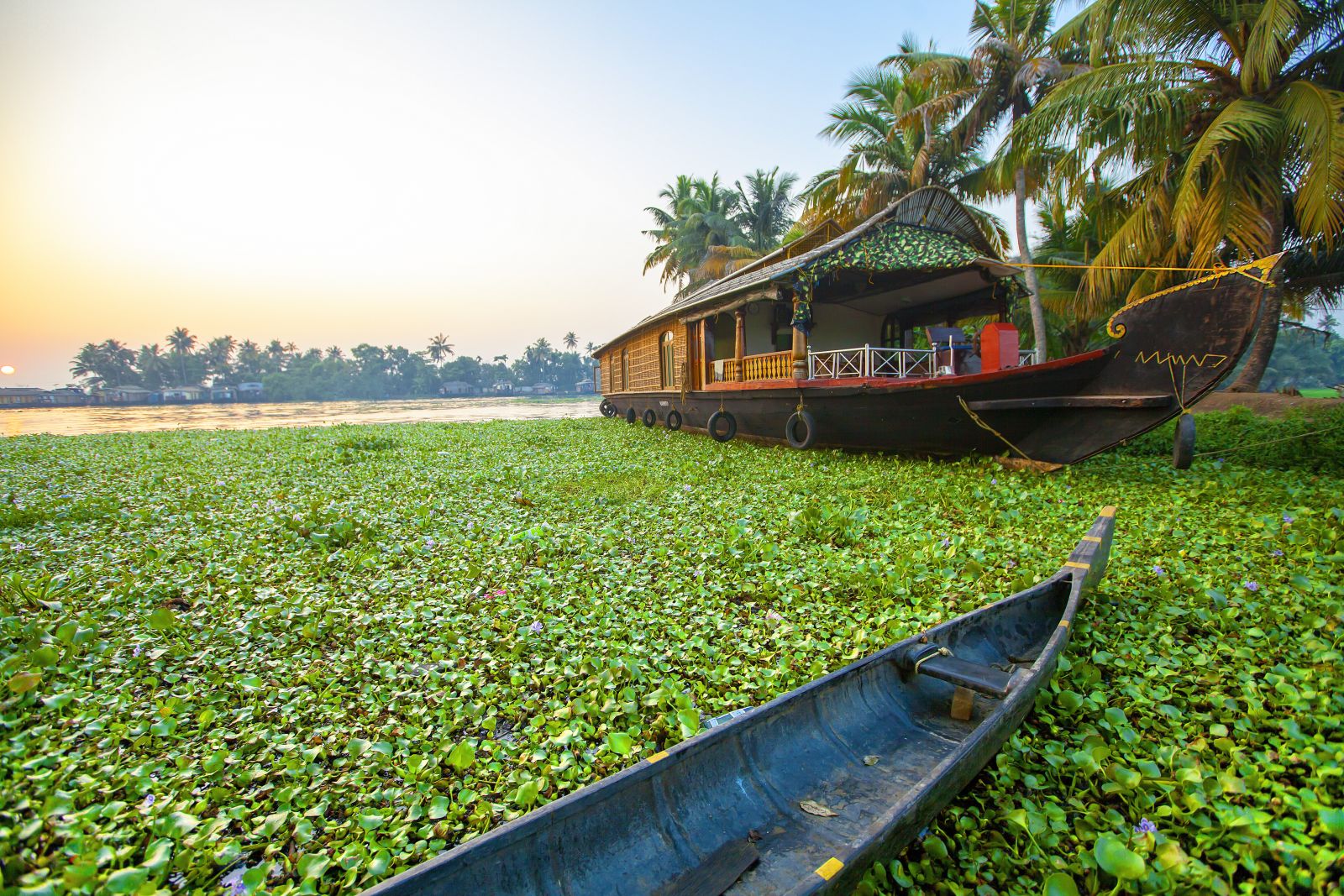 Rice barge and canoe in the backwaters of Kerala in India