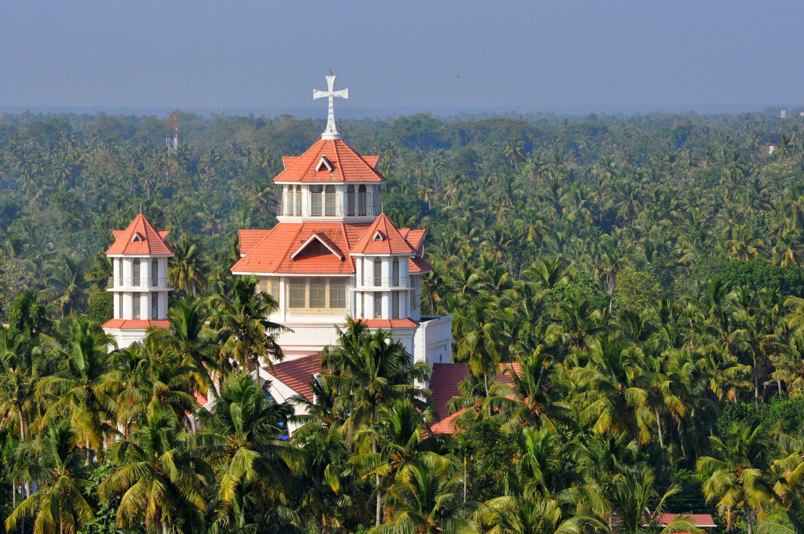 The spire of a church rising above the palms in Kerala, southern India
