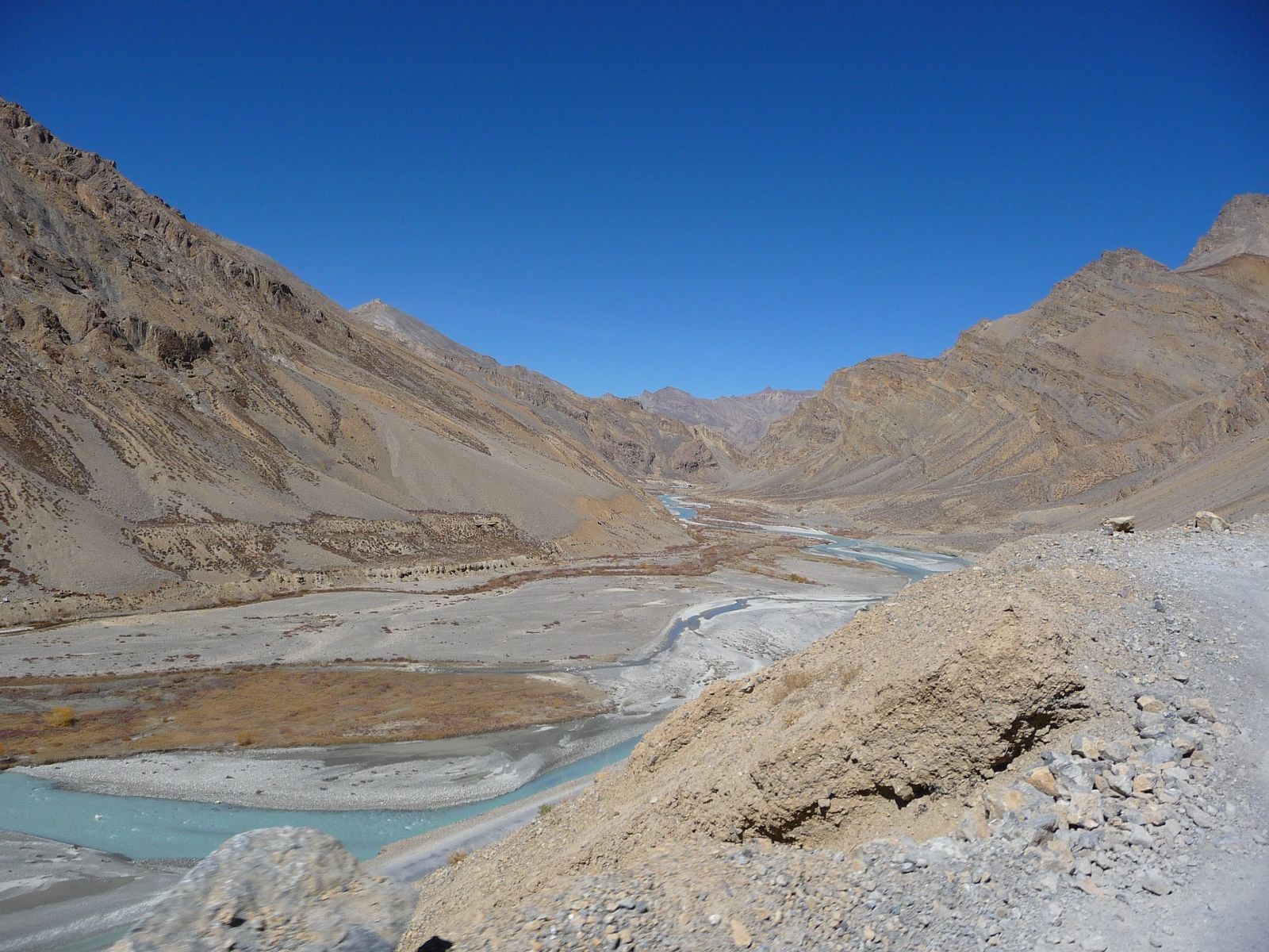Rocky landscape with water streams and a bight blue sky in Ladakh, India