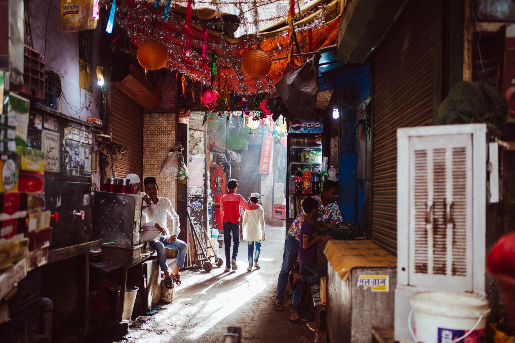 A family walking down Delhi's famous Paranthe Wali Gali street
