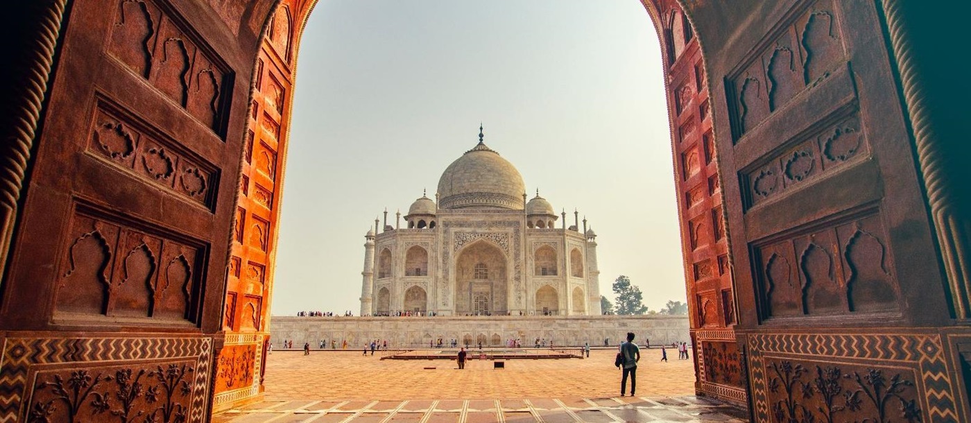 View of the Taj Mahal in India through an ornate doorway