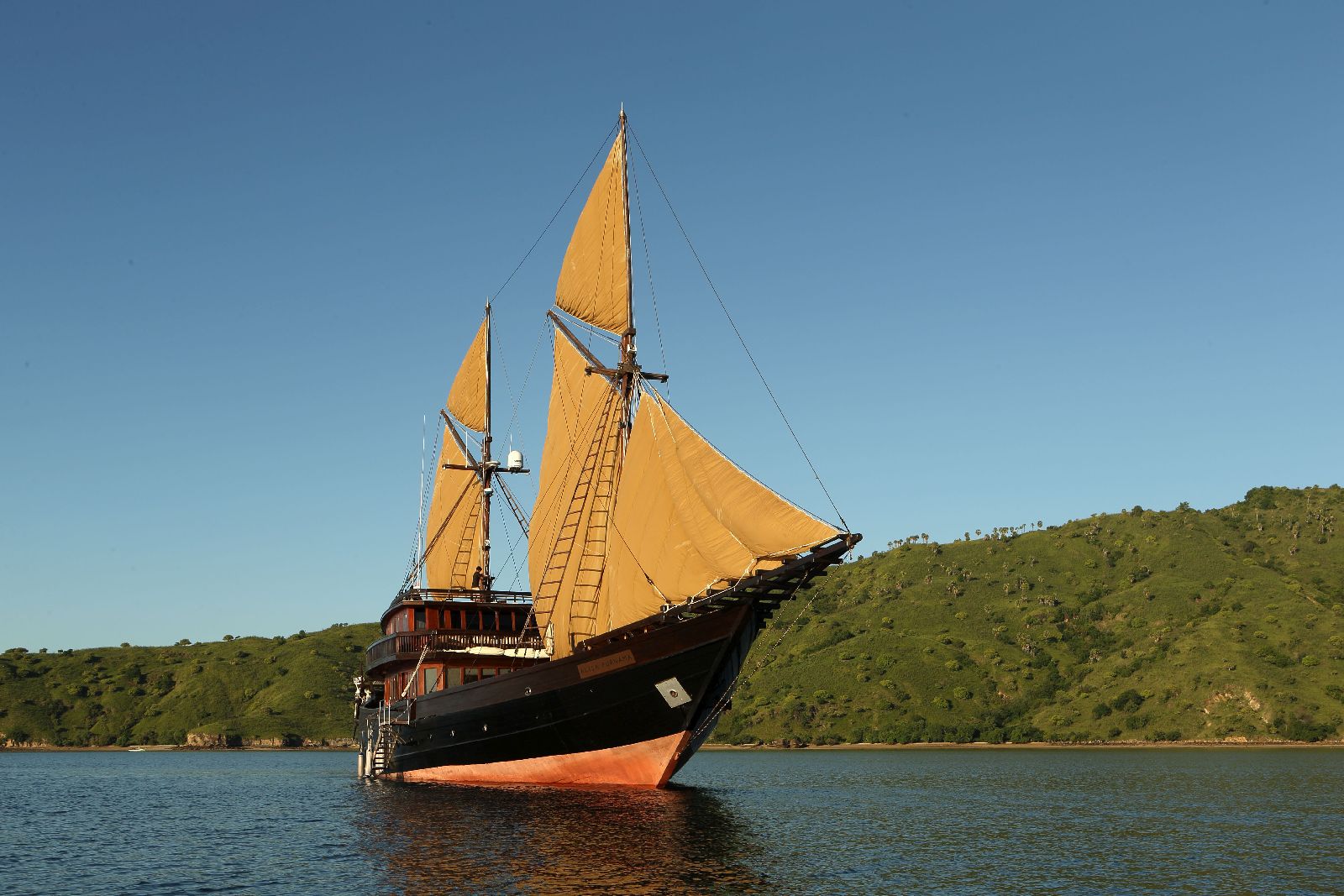 The Alila Purnama luxury phinisi at full sail in Indonesia