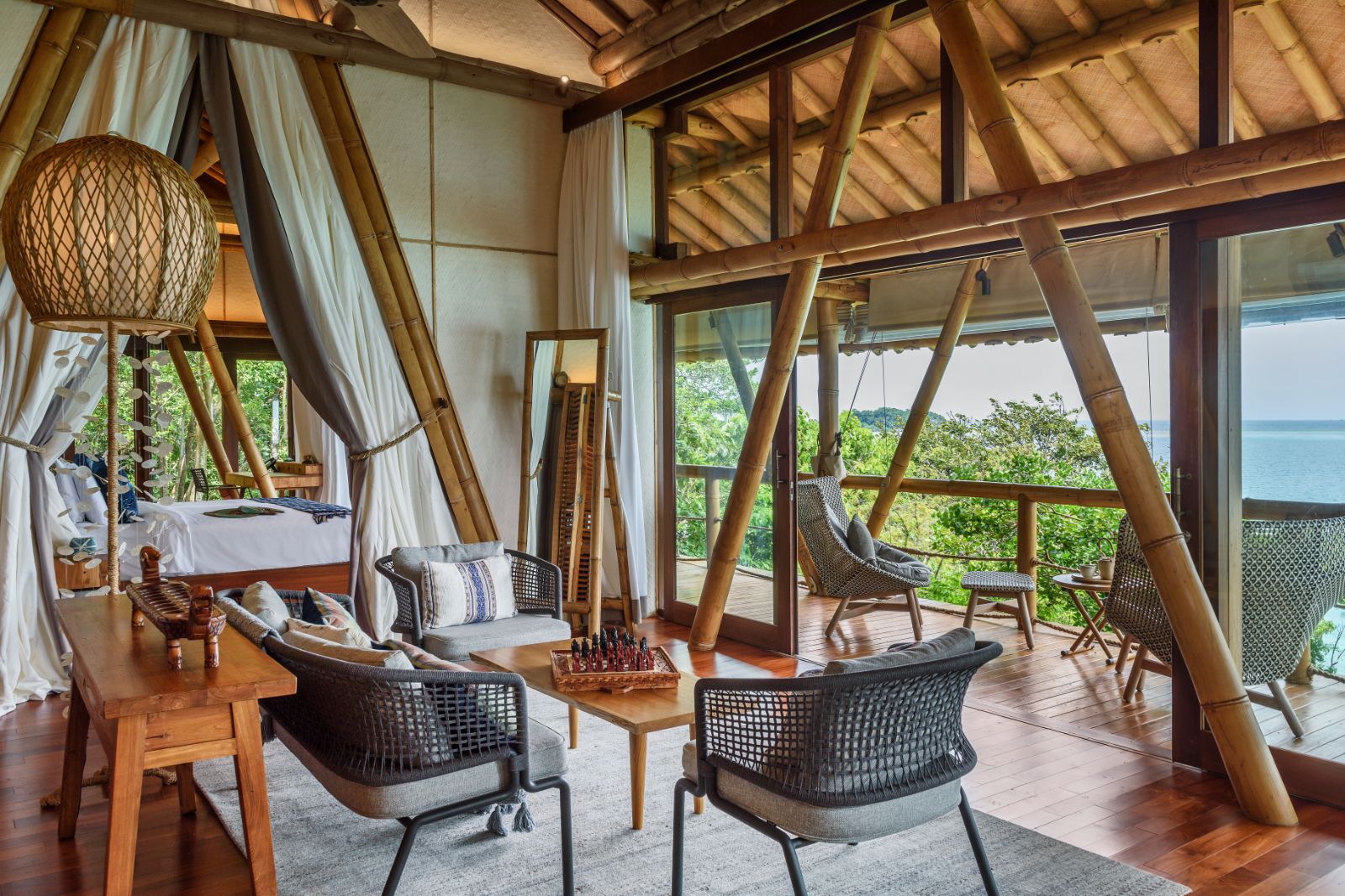 Living area and bedroom in a lodge at Bawah Reserve in Indonesia