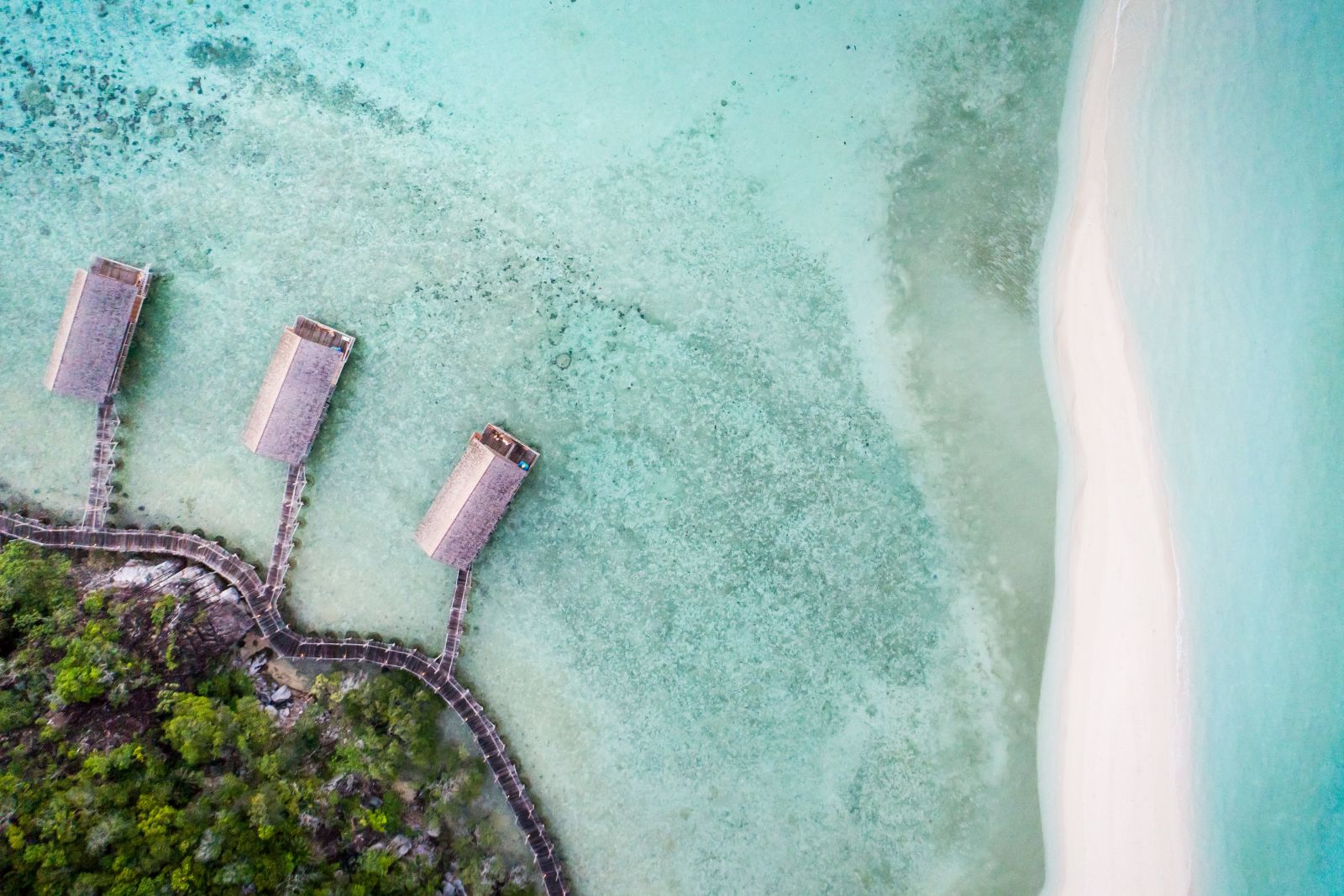 Aerial view of the overwater bungalows at Bawah Reserve Indonesia