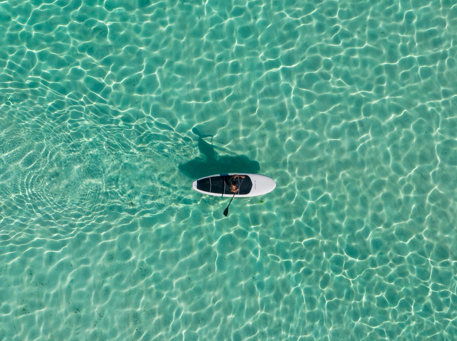 Stand up paddle boarding on the grounds of Cap Karoso resort on Sumba island in Indonesia