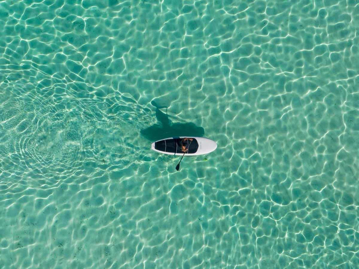 Stand up paddle boarding on the grounds of Cap Karoso resort on Sumba island in Indonesia
