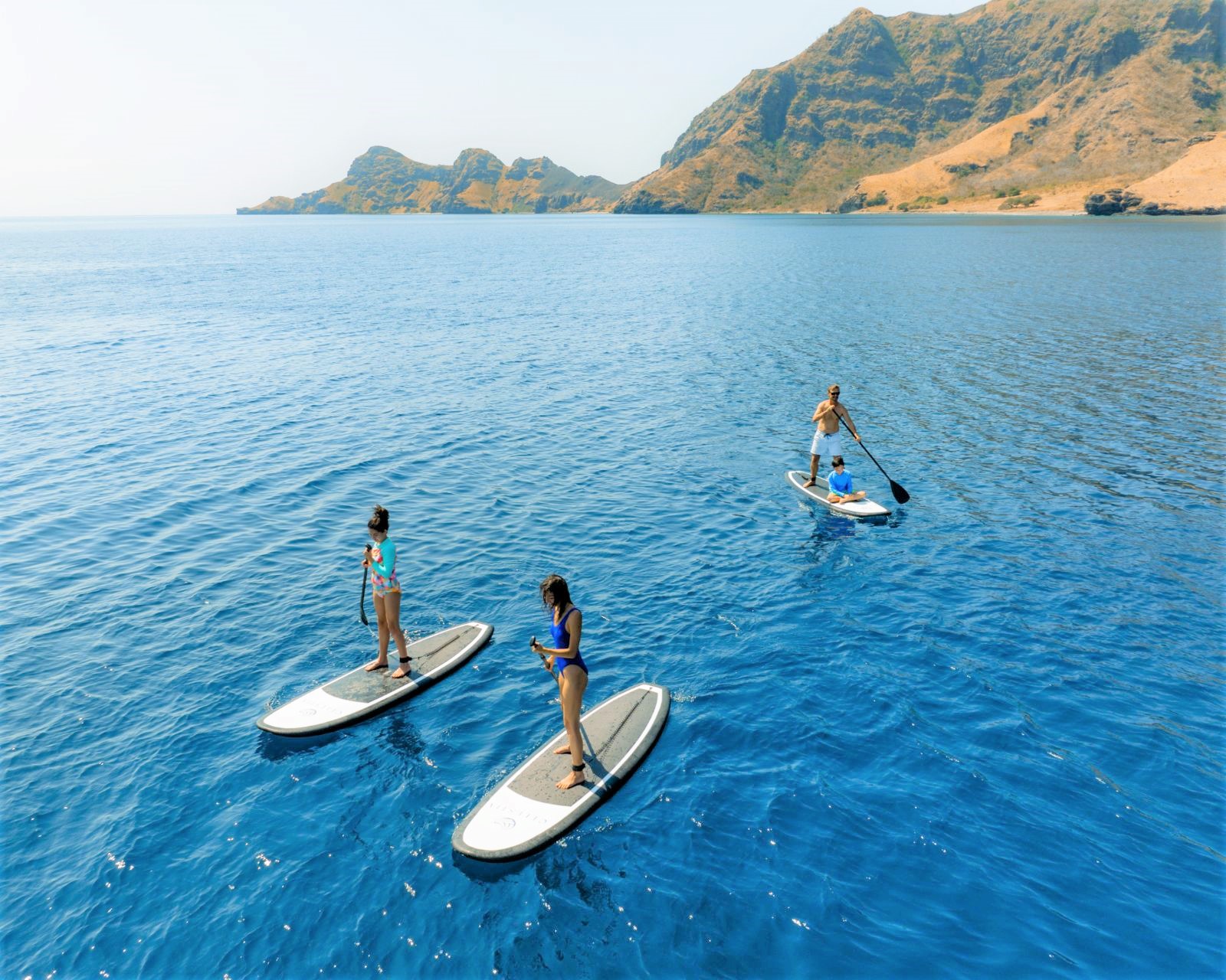 Paddleboarding on the water of Komodo and Raja Ampat from the Celestia phinisi in Indonesia