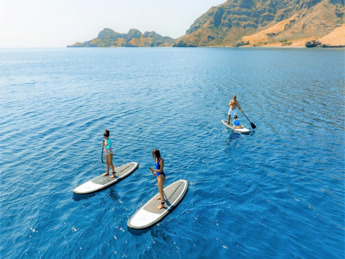 Paddleboarding on the water of Komodo and Raja Ampat from the Celestia phinisi in Indonesia