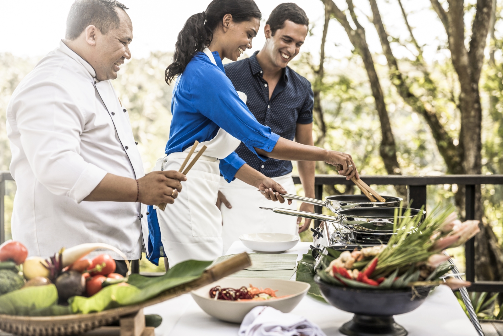 A couple enjoying a cooking class, instructed by a professional chef