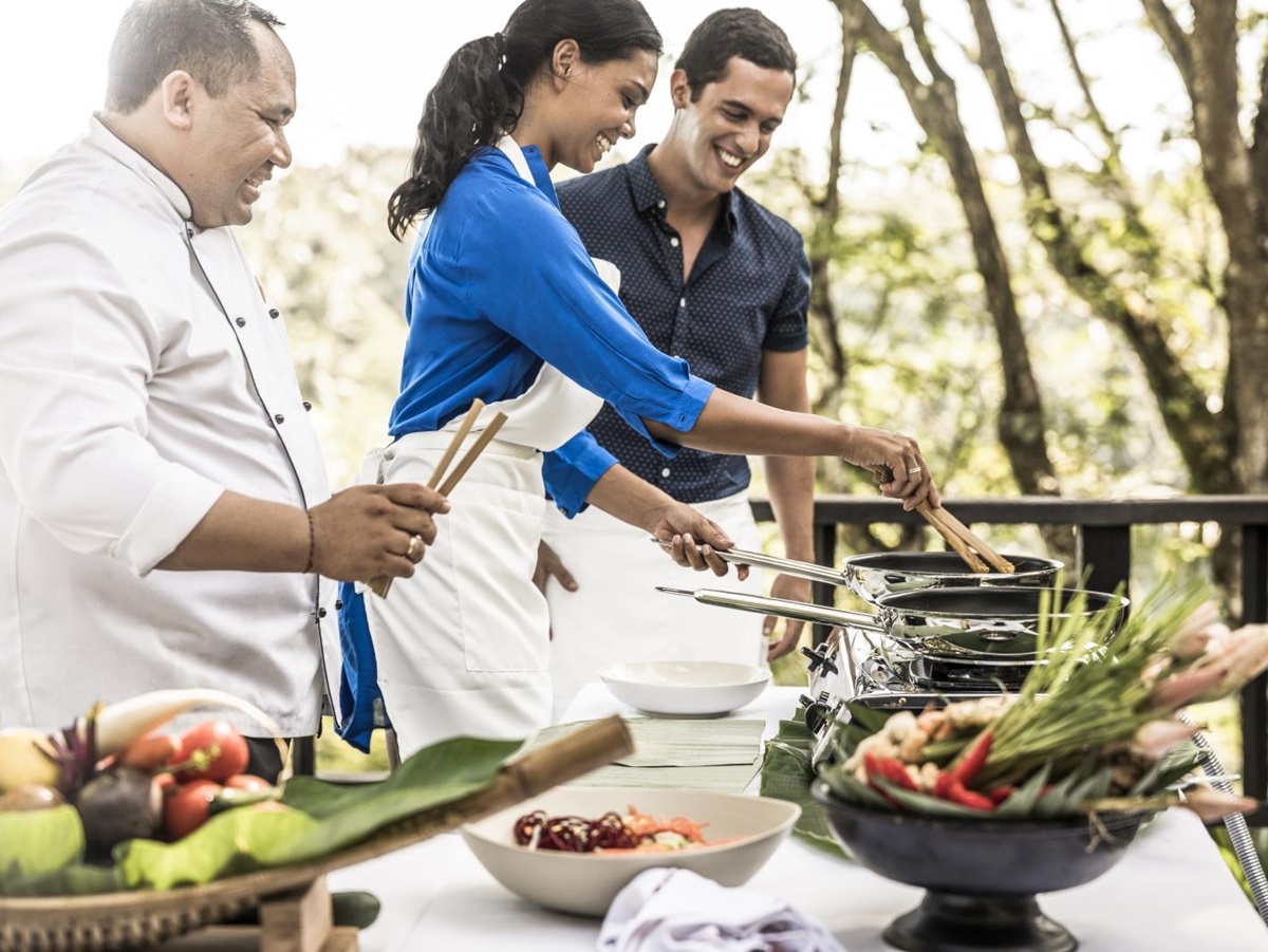 A couple enjoying a cooking class, instructed by a professional chef