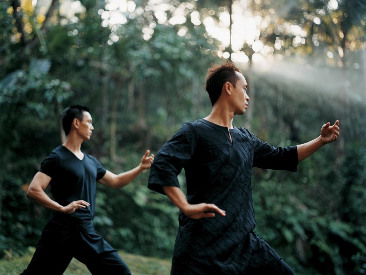 Two men practising Tai Chi in the jungle