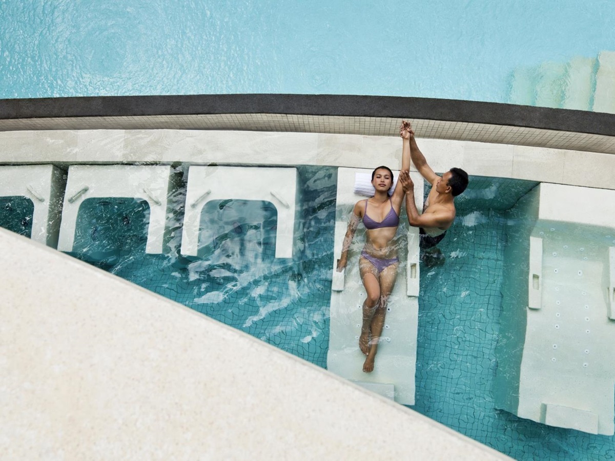Woman in the Vitality Pool, with instructor streching her arm