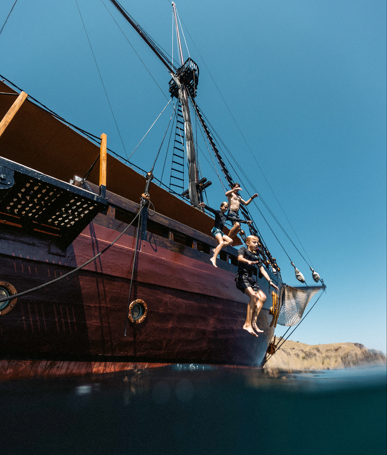 Guests jumping off El Aleph luxury phinisi in Indonesia