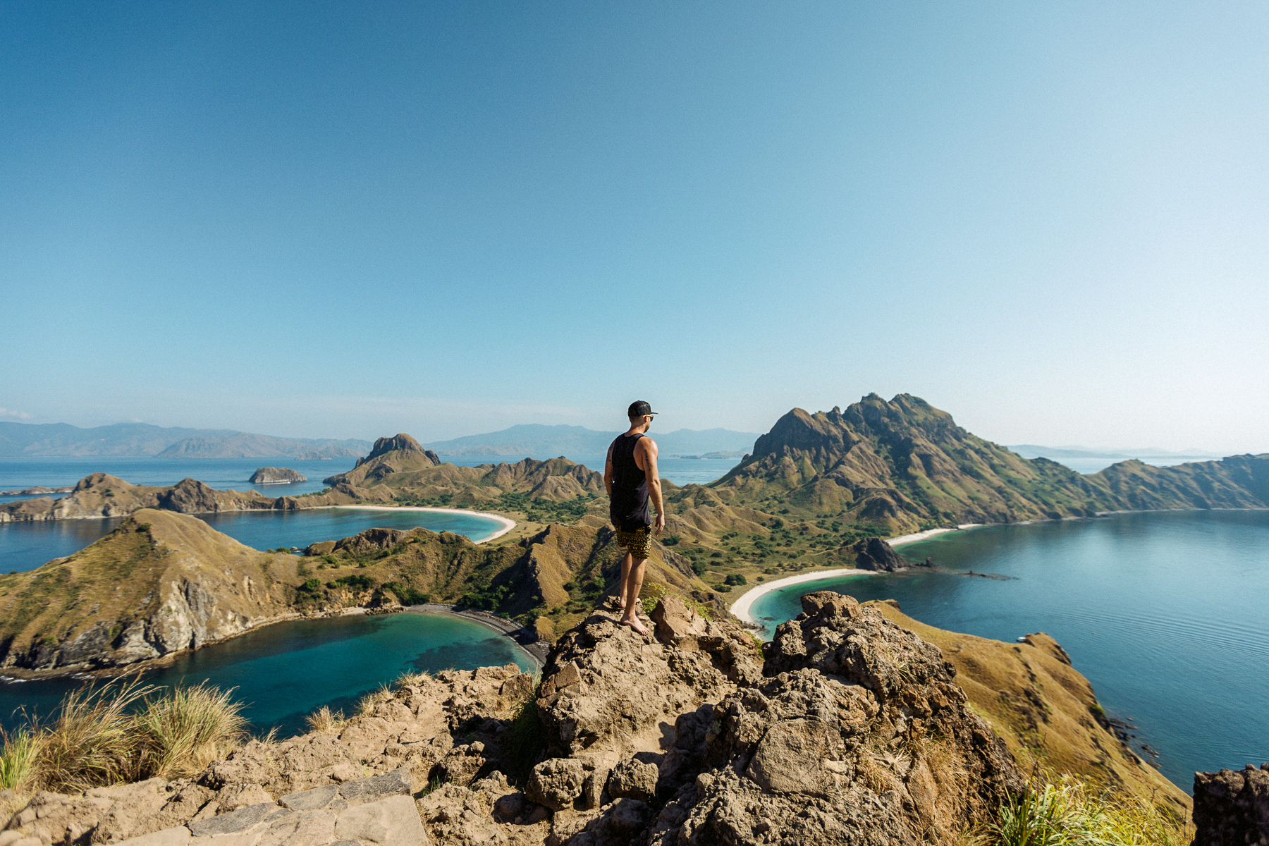 A man looking over the Komodo Islands from the El Aleph luxury phinisi in Indonesia