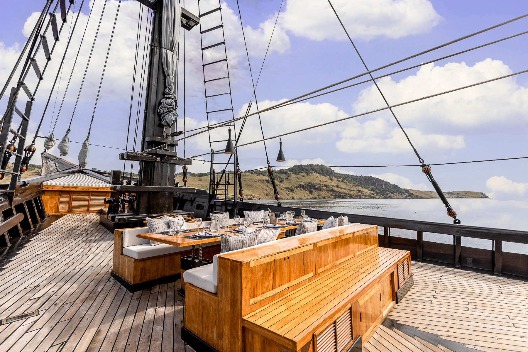 Outdoor dining onboard the El Aleph luxury phinisi in Indonesia