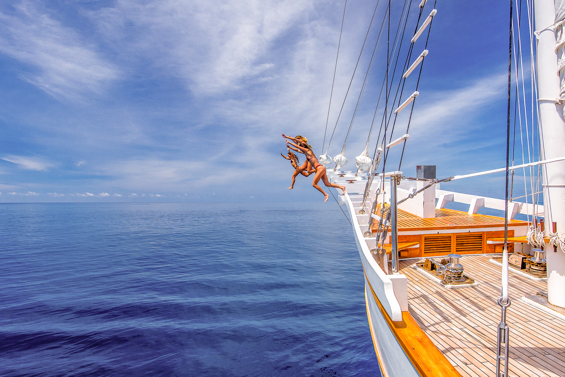 Guests jumping off the Fenides luxury phinisi in Indonesia