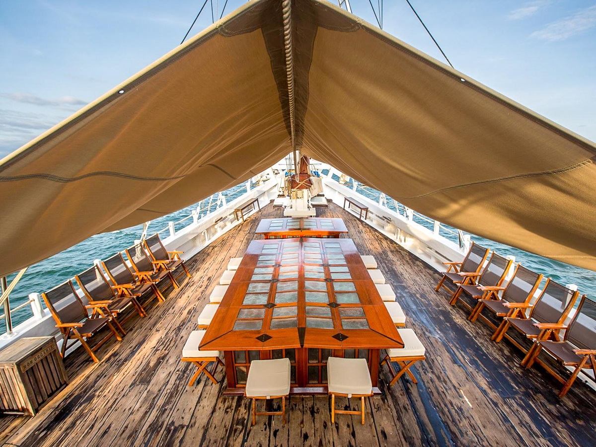 Alfresco dining setup on the deck of the Katharina luxury phinisi in Indonesia