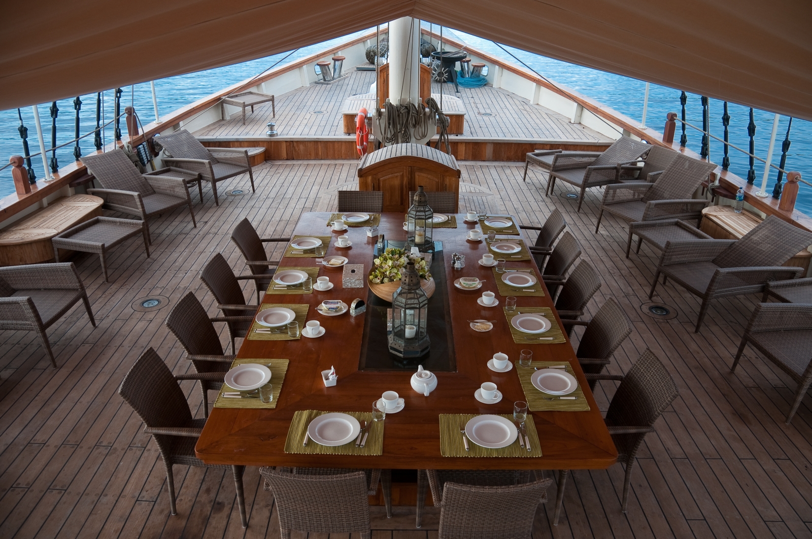 Dining on deck with large table under canvas